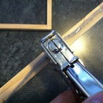 stapling the screen on the frame to make paper