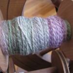 two ply yarn on the bobbin of a spinning wheel