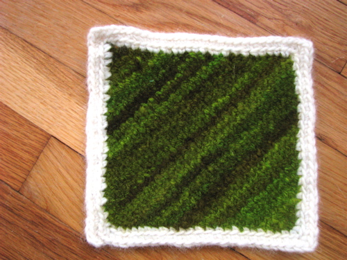 hand dyed, hand spun Romney wool potholder knit on bias and fulled