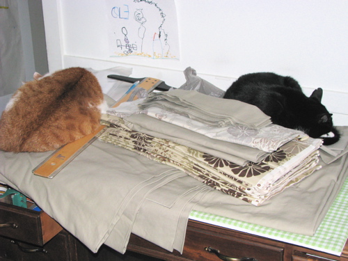 cats sleeping on fabric