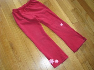 yoga pants embellished with hand stitched felt flowers to cover hole in knee