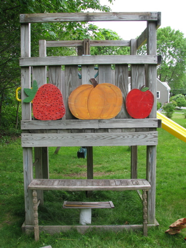 salvaged wood counter and painted wood fruit on swingset slide fort treehouse