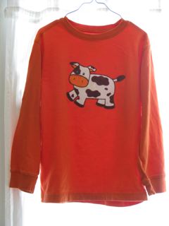 orange tee shirt with hand drawn cartoon cow applique