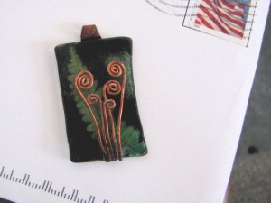 fiddlehead pendant made of copper wire and shrink plastic