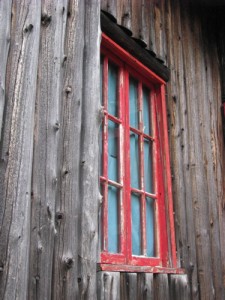 old red trim window in log building