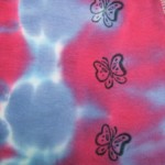 detail of stamped butterflies on pink and purple tie dye baby onesie